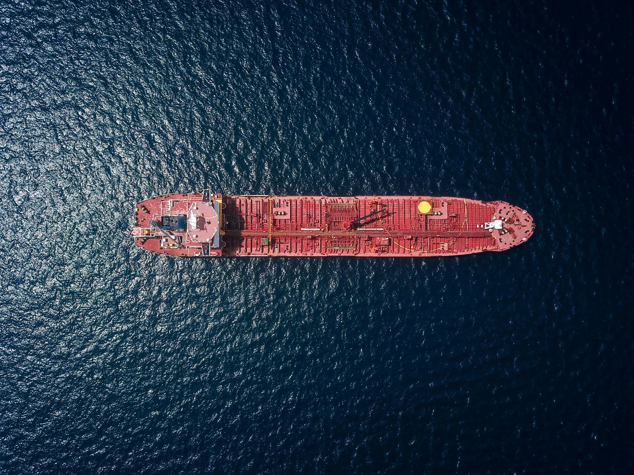 Aerial view of a cargo tanker moving through open water