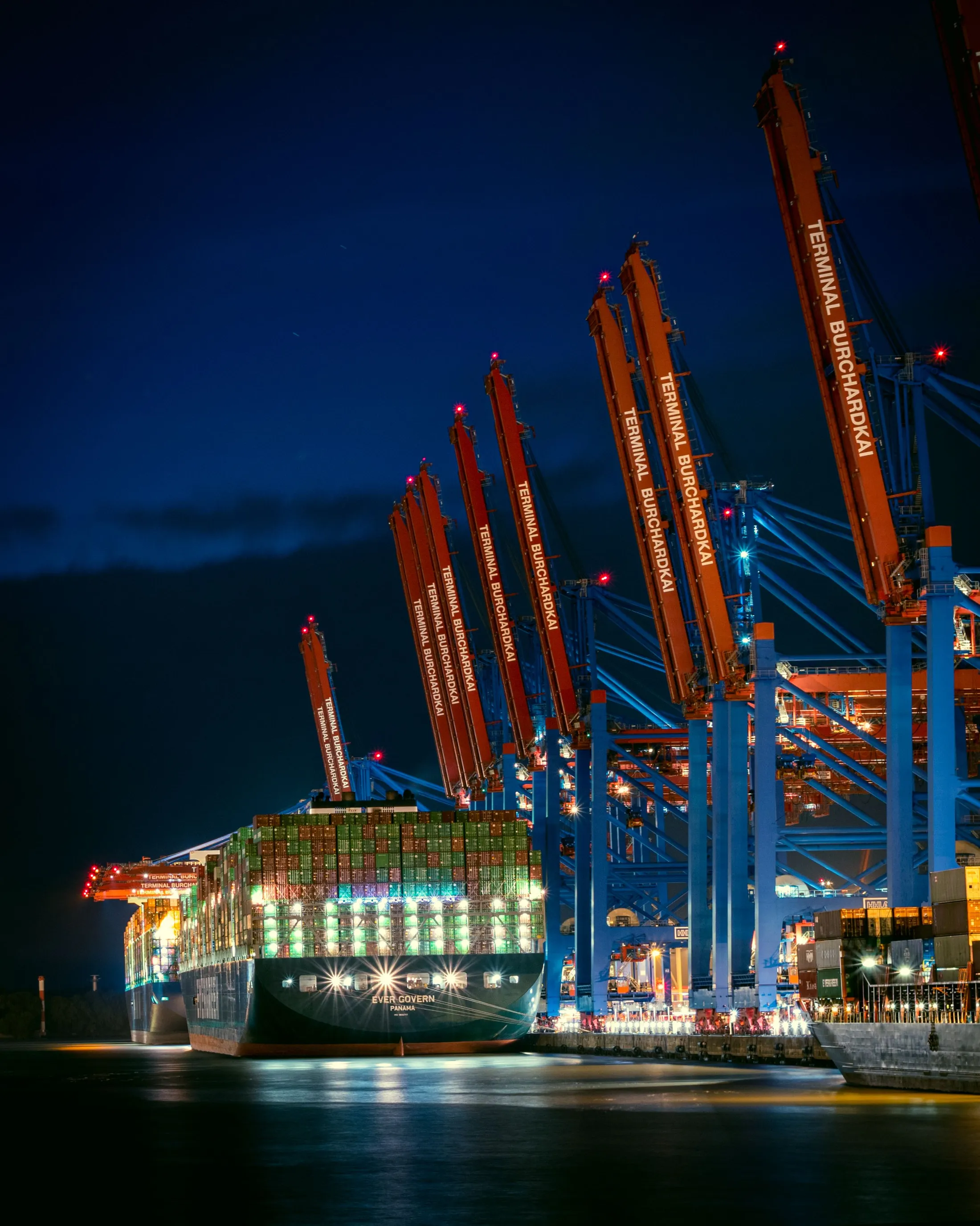 Close-up of stacked shipping containers in red, yellow, and blue